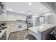 Well-lit kitchen with stainless steel appliances, white cabinets, and tile flooring at 2862 Lomond Dr, Palm Harbor, FL 34684