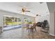 Bright living area with tile flooring, ceiling fans, and access to the outdoor patio at 2862 Lomond Dr, Palm Harbor, FL 34684