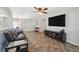 Spacious living room features a ceiling fan, television, and ample natural light at 2862 Lomond Dr, Palm Harbor, FL 34684