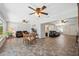 Spacious living area with multiple ceiling fans, tile flooring, and multiple seating arrangements at 2862 Lomond Dr, Palm Harbor, FL 34684