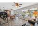 Bright and airy living area featuring tile flooring, ceiling fans, and an outdoor view at 2862 Lomond Dr, Palm Harbor, FL 34684
