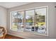 View of lush backyard, pond, and covered patio from sunroom at 2862 Lomond Dr, Palm Harbor, FL 34684
