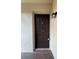 Unit's front door with an updated door, lighting fixture, and secure lock at 2971 Estancia Blvd # 310, Clearwater, FL 33761