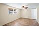 Well-lit bedroom with hardwood floors, ceiling fan, and window with exterior view at 3736 Sail Dr, New Port Richey, FL 34652