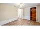 Bedroom featuring wood-look floors, a ceiling fan, and a closet at 3736 Sail Dr, New Port Richey, FL 34652