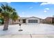 Charming single-story home with palm tree, gray accent, and a spacious driveway leading to a screened-in two-car garage at 3736 Sail Dr, New Port Richey, FL 34652