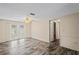 Living room with wood-look floors and french doors to the outside at 3736 Sail Dr, New Port Richey, FL 34652