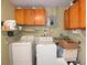 Functional laundry room with washer, dryer, and ample storage at 4051 Ironware Dr, Holiday, FL 34691