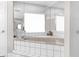 Luxurious bathtub surrounded by white tile and mirrored walls, offering a relaxing spa-like experience at 4603 Lake In The Woods Dr, Spring Hill, FL 34607