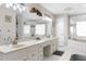 Bright bathroom showcasing double vanity, mirrors, and a large soaking tub at 4603 Lake In The Woods Dr, Spring Hill, FL 34607