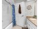 Bathroom showcasing white vanity with granite countertop, shower with glass door, and nautical decor at 4603 Lake In The Woods Dr, Spring Hill, FL 34607