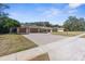 Beautiful home with a large brick driveway and a well-maintained lawn at 4603 Lake In The Woods Dr, Spring Hill, FL 34607
