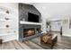 Stone fireplace focal point with built in shelving in a bright and airy living room at 4603 Lake In The Woods Dr, Spring Hill, FL 34607