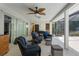 Relaxing covered patio with cozy wicker furniture, ceiling fan, and screened enclosure overlooking lush greenery at 4603 Lake In The Woods Dr, Spring Hill, FL 34607