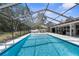 Beautiful screened-in pool with an attached spa and plenty of room for entertaining at 4603 Lake In The Woods Dr, Spring Hill, FL 34607