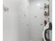 Clean, tiled shower adorned with delicate floral accents, complemented by a convenient storage rack at 4603 Lake In The Woods Dr, Spring Hill, FL 34607