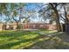 This large backyard is fully fenced, with mature trees offering ample shade and privacy at 4929 Avery Rd, New Port Richey, FL 34652