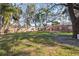 Expansive, fenced backyard featuring mature shade trees and lush green grass at 4929 Avery Rd, New Port Richey, FL 34652