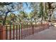 Fenced backyard with mature trees viewed from a wood deck at 4929 Avery Rd, New Port Richey, FL 34652