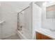 Bathroom featuring marble-patterned tiling and a bathtub with shower at 4929 Avery Rd, New Port Richey, FL 34652