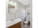 Bathroom featuring marble-patterned tiling and a wooden vanity at 4929 Avery Rd, New Port Richey, FL 34652