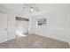 This bedroom has tile flooring, a ceiling fan, closet, and window at 4929 Avery Rd, New Port Richey, FL 34652