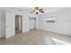This bedroom features tile floors, a closet, and a ceiling fan at 4929 Avery Rd, New Port Richey, FL 34652