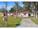 Charming single-story home with red tile roof, wooden fence, and well-kept front yard at 4929 Avery Rd, New Port Richey, FL 34652
