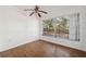 The bright living room features wood-look tile flooring, and a window overlooking the backyard at 4929 Avery Rd, New Port Richey, FL 34652