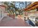 Outdoor kitchen with a grill and counter space on a wooden deck with fencing at 4929 Avery Rd, New Port Richey, FL 34652