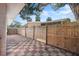 Private outdoor patio area featuring a checkerboard patterned tile, surrounded by a wooden fence at 4929 Avery Rd, New Port Richey, FL 34652