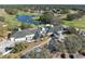 High angle view of a golf course and community clubhouse, surrounded by lush landscaping at 5351 Championship Cup Ln, Spring Hill, FL 34609