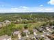 Expansive aerial view of a well-manicured neighborhood with mature trees, green spaces, and golf course at 5351 Championship Cup Ln, Spring Hill, FL 34609