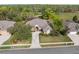 Aerial view of a lovely home featuring mature landscaping, a paved driveway, and views of the golf course at 5351 Championship Cup Ln, Spring Hill, FL 34609