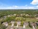 Aerial view showcasing homes bordering the scenic golf course, surrounded by mature trees and pristine fairways at 5351 Championship Cup Ln, Spring Hill, FL 34609