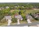 Aerial view of a beautiful neighborhood with golf course, mature trees, and well-maintained landscaping at 5351 Championship Cup Ln, Spring Hill, FL 34609