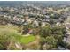 Scenic aerial view highlighting a golf course community with well-manicured lawns, mature trees, and picturesque fairways at 5351 Championship Cup Ln, Spring Hill, FL 34609