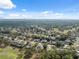 Wide aerial shot showcasing the golf community, beautiful homes, and lush green landscape under a bright blue sky at 5351 Championship Cup Ln, Spring Hill, FL 34609