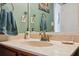 Close-up of the bathroom featuring wood vanity with a neutral countertop, perfect for a relaxing experience at 5351 Championship Cup Ln, Spring Hill, FL 34609