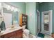 Well-lit bathroom with a wood vanity, cabinet, tile flooring, providing a refreshing and functional space at 5351 Championship Cup Ln, Spring Hill, FL 34609
