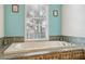 Close up of bathroom showcasing the large tub and tile accents with natural light streaming in at 5351 Championship Cup Ln, Spring Hill, FL 34609