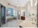 Luxurious bathroom with double sinks, a vanity, a separate shower, and a large bathtub at 5351 Championship Cup Ln, Spring Hill, FL 34609