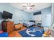 Cozy bedroom featuring an anchor rug, bed, and playful decor, creating a charming and comfortable atmosphere at 5351 Championship Cup Ln, Spring Hill, FL 34609