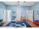 Bright bedroom with blue walls, wood floors, and plenty of room to play at 5351 Championship Cup Ln, Spring Hill, FL 34609