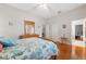 Inviting bedroom featuring hardwood floors, comfortable furnishings, and easy access to an adjacent room at 5351 Championship Cup Ln, Spring Hill, FL 34609