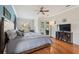 Comfortable bedroom with a ceiling fan, large windows, and a TV entertainment center at 5351 Championship Cup Ln, Spring Hill, FL 34609