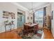 Charming dining room featuring a large window, hardwood floors, and display cabinets at 5351 Championship Cup Ln, Spring Hill, FL 34609