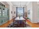 Traditional dining room featuring a large window, hardwood floors, and a classic china cabinet at 5351 Championship Cup Ln, Spring Hill, FL 34609