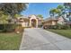 Beautiful single-story home featuring mature landscaping, a long driveway, and attached garage at 5351 Championship Cup Ln, Spring Hill, FL 34609