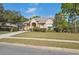 Well-maintained single-story home with a manicured lawn and beautiful landscaping at 5351 Championship Cup Ln, Spring Hill, FL 34609
